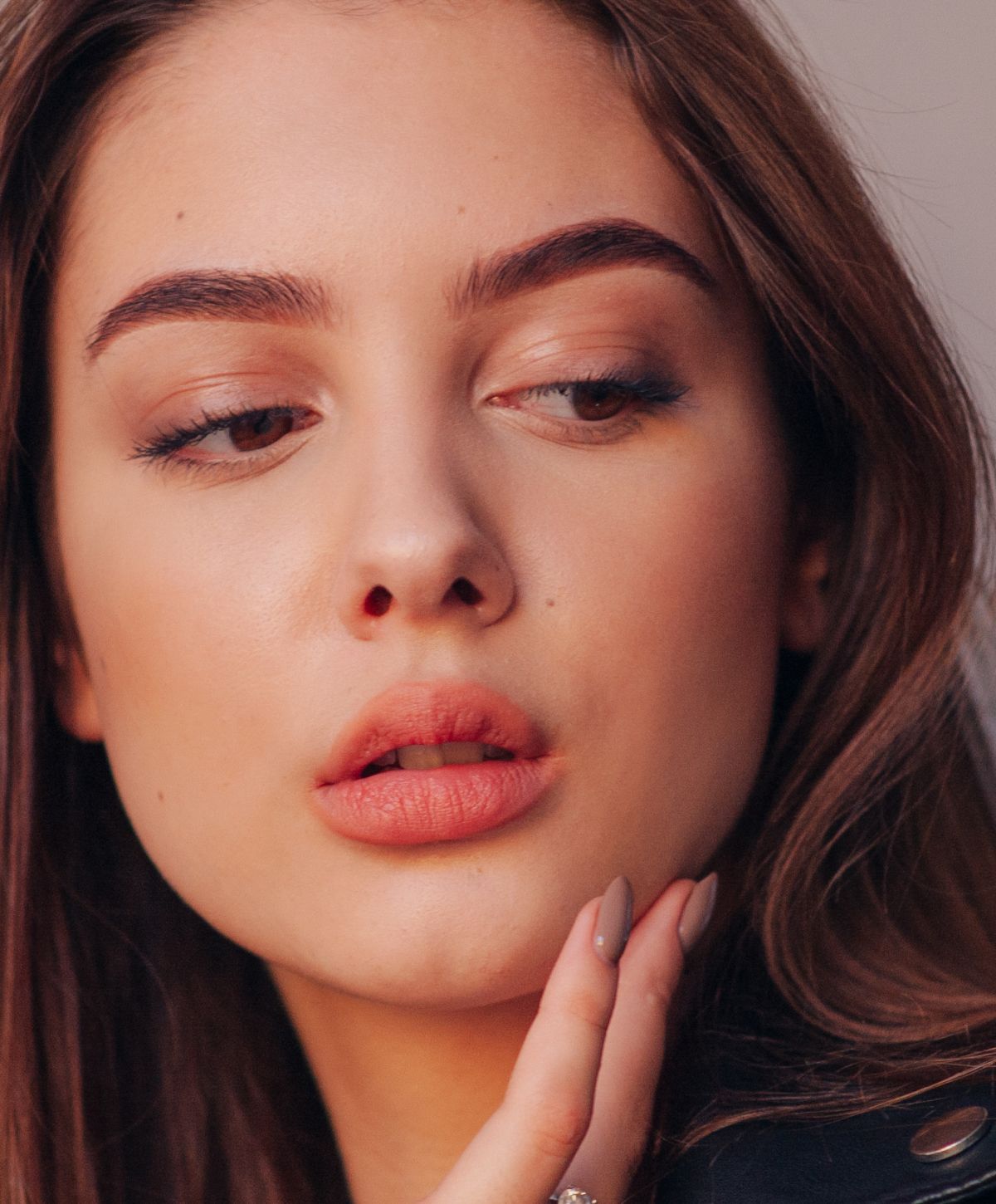 Close-up of a woman's face, soft makeup.